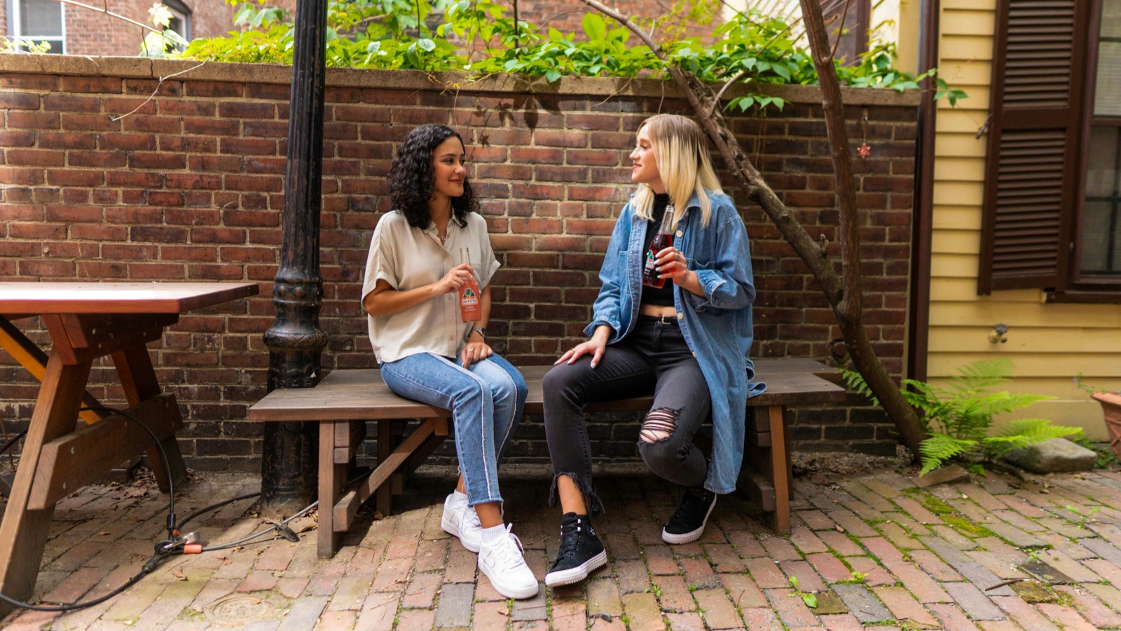 Two friends chatting on a bench